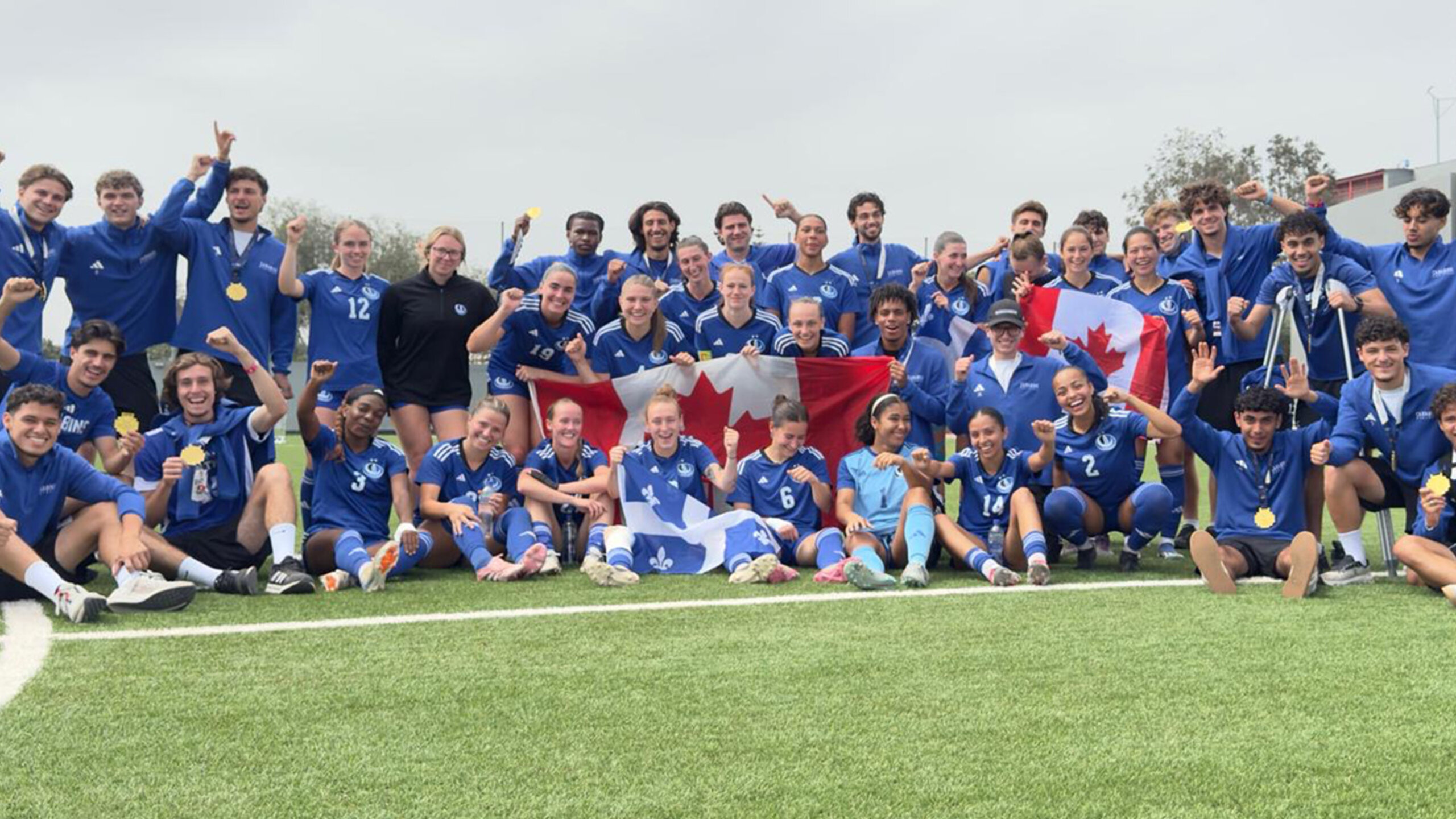 Two Carabins teams on a soccer field, wearing medals and posing with the flags of Canada and Quebec