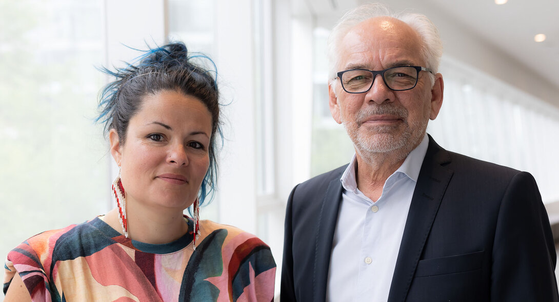 Marine Agogué et Ghislain Picard, debout côte à côte dans un corridor lumineux avec de grandes fenêtres. 